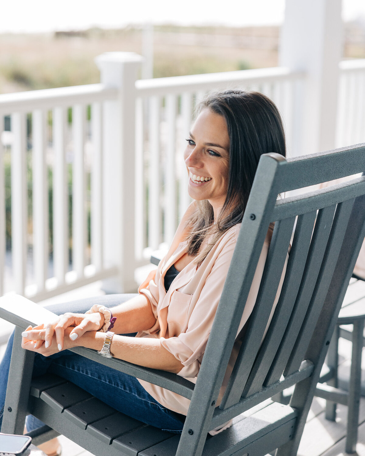 A Real Estate InvestHER founder seated in a porch rocking chair